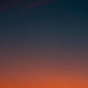 Fiery sunset with crescent moon Crescent moon and fiery orange sunset horizon