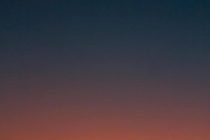 Fiery sunset with crescent moon Crescent moon and fiery orange sunset horizon