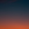 Fiery sunset with crescent moon Crescent moon and fiery orange sunset horizon