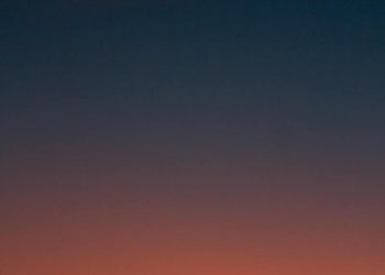 Fiery sunset with crescent moon Crescent moon and fiery orange sunset horizon