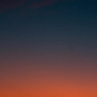 Fiery sunset with crescent moon Crescent moon and fiery orange sunset horizon