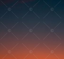 Crescent moon and fiery orange sunset horizon