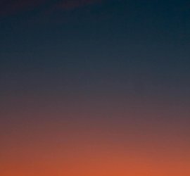 Fiery sunset with crescent moon Crescent moon and fiery orange sunset horizon