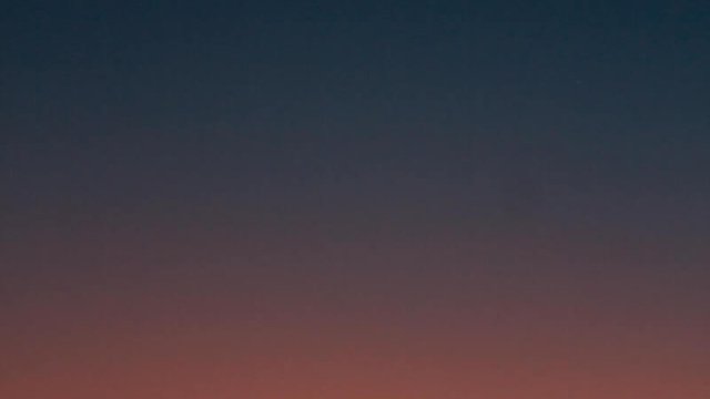 Fiery sunset with crescent moon Crescent moon and fiery orange sunset horizon