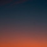 Fiery sunset with crescent moon Crescent moon and fiery orange sunset horizon