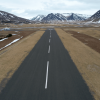 Lonely road stretching through mountain valley Long straight mountain road disappearing into the distance